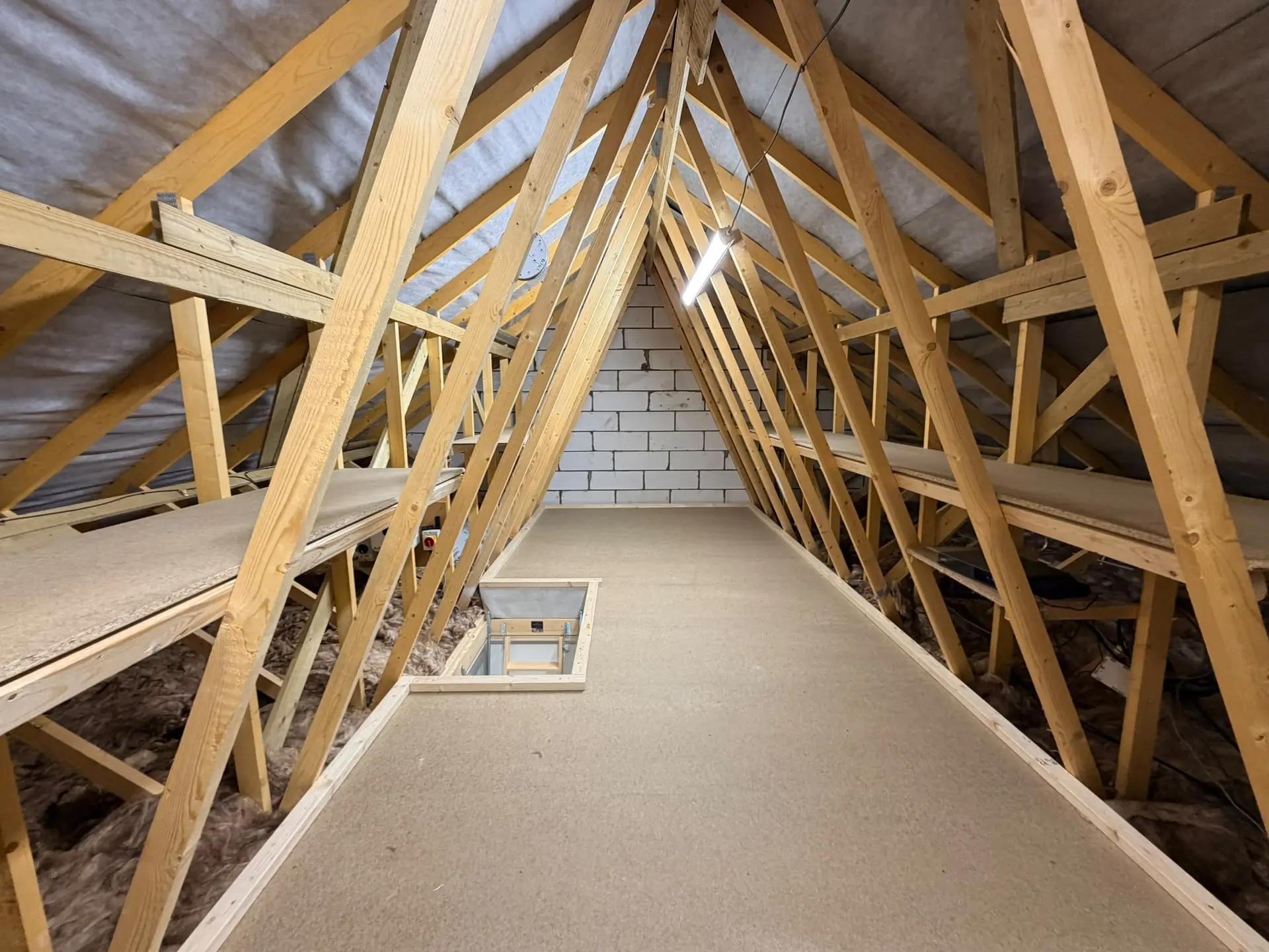 loft boarding in a new build with loft shelving and loft lighting